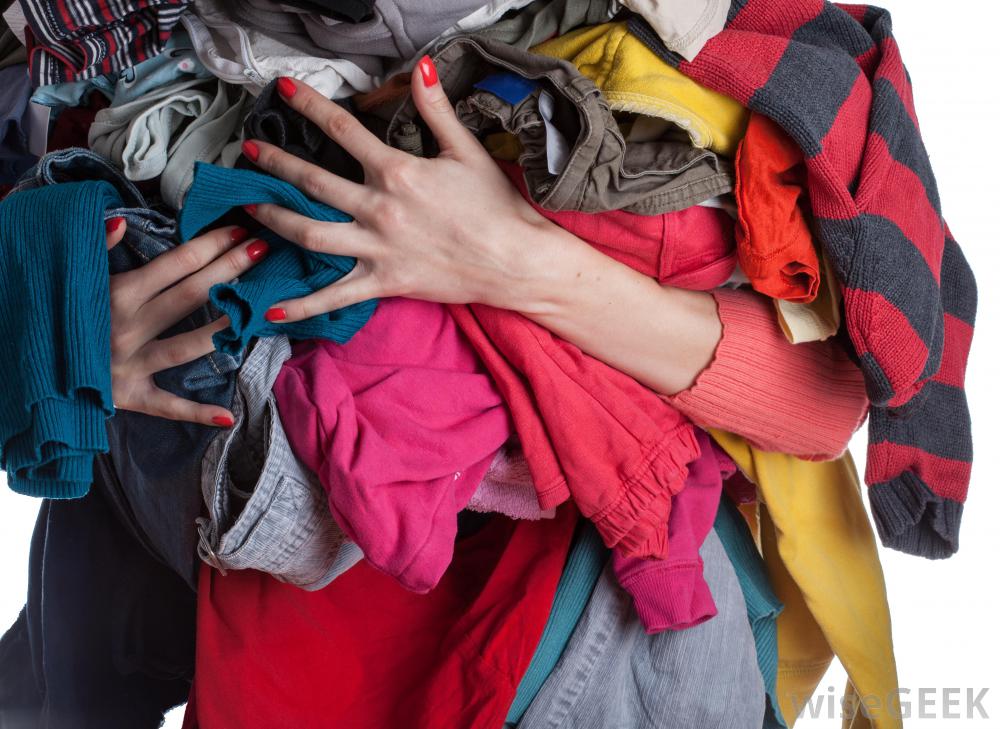 woman-holding-pile-of-clothes - Big Brothers Big Sisters of Greater Halifax